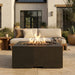 Square concrete outdoor fire pit table with flames in front of a house