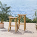 Natural rattan outdoor bar stools on a wooden deck with an ocean view.