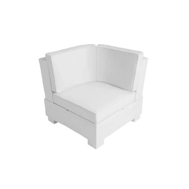 A modern white corner armchair with a low-profile geometric design, featuring a thick cushioned seat and backrest, isolated on a white background.