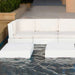 White in-pool outdoor modular patio seating with a low in-pool cube coffee table.
