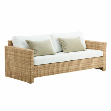 Natural rattan outdoor 3-seater sofa with woven frame, white cushions and beige accent pillows.