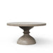 Beige round concrete outdoor dining table with sculpted hourglass-shaped base on a white background