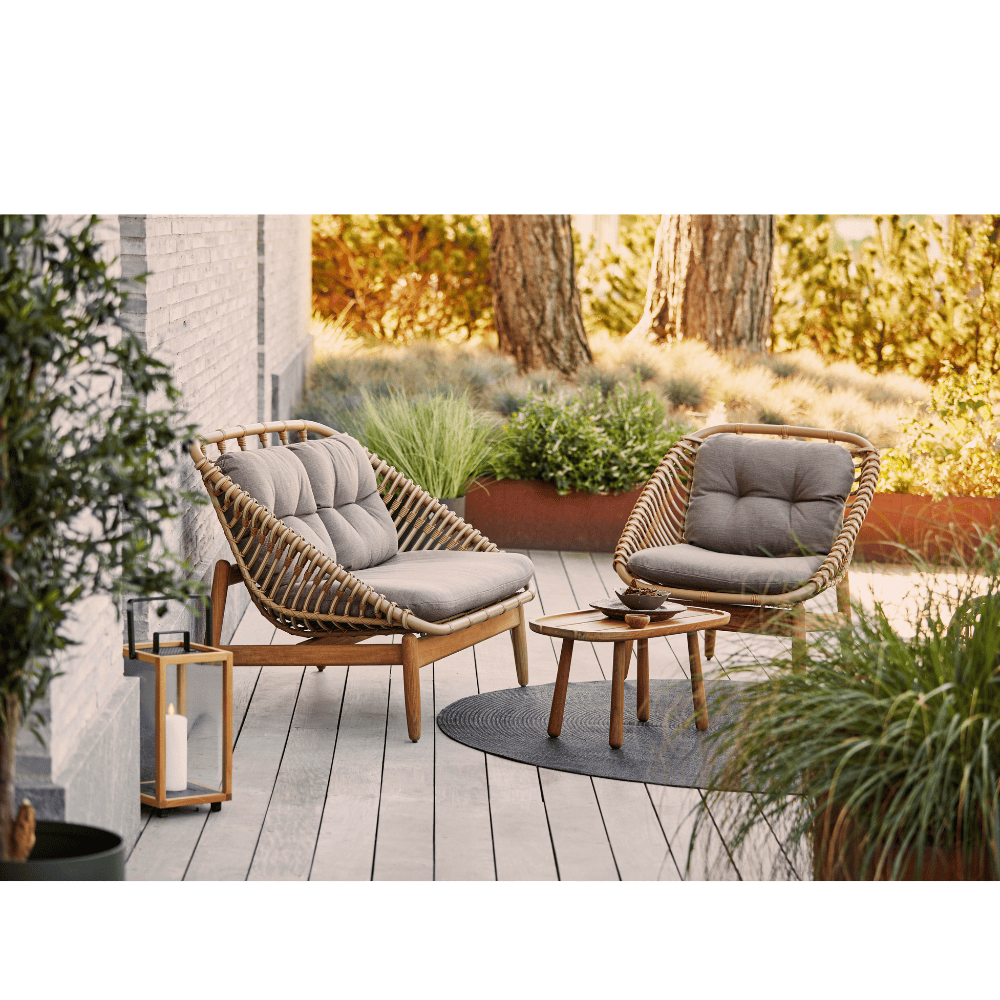 Boxhill's String light brown outdoor 2-seater sofa-teak frame with string lounge chair and teak side table placed in patio