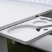 Close-up of a white plastic tray insert with circular cutouts and a small triangular notch, attached to a white table surface.