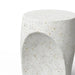 Close-up of round white speckled concrete outdoor side table with curved indentations on a white background