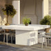 Patio dining area with square white speckled outdoor dining table, gray chairs and potted plants