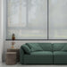  Minimalist living room with two gray cylindrical outdoor side tables in different sizes beside a green sofa