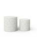 Two cylindrical concrete outdoor side tables with speckled texture in different sizes on a white background