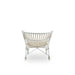 White rattan outdoor lounge chair viewed from the rear with a sculptural woven frame.