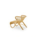 Natural rattan outdoor lounge chair viewed from the angled rear with a sculptural woven frame.
