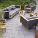 Boxhill's Angle 3-Seater Teak Frame Sofa lifestyle image with Angle Teak Frame Lounge Chair at the garden