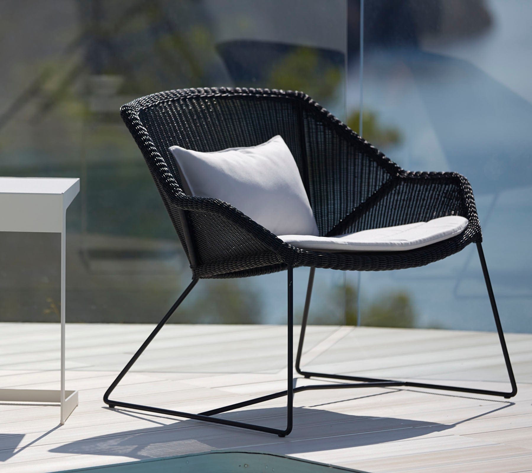 Boxhill's Breeze Outdoor Lounge Chair Black lifestyle image with white cushion