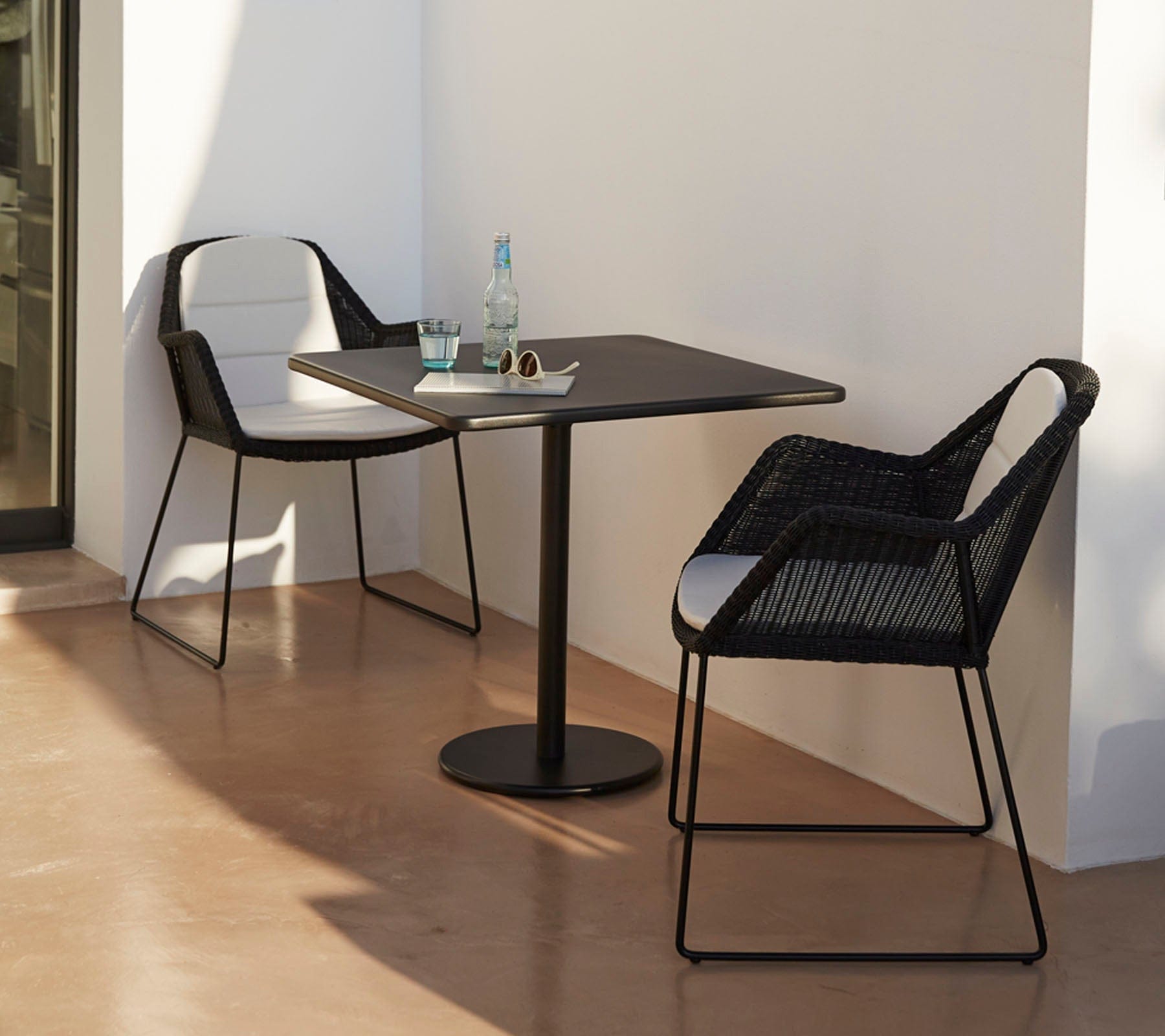 Boxhill's Breeze Dining Weave Chair Black lifestyle image with square table