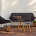 Boxhills' Breeze 2-Seater Outdoor Garden Sofa Black lifestyle image with 2 Area Coffee Table Chair on wooden platform