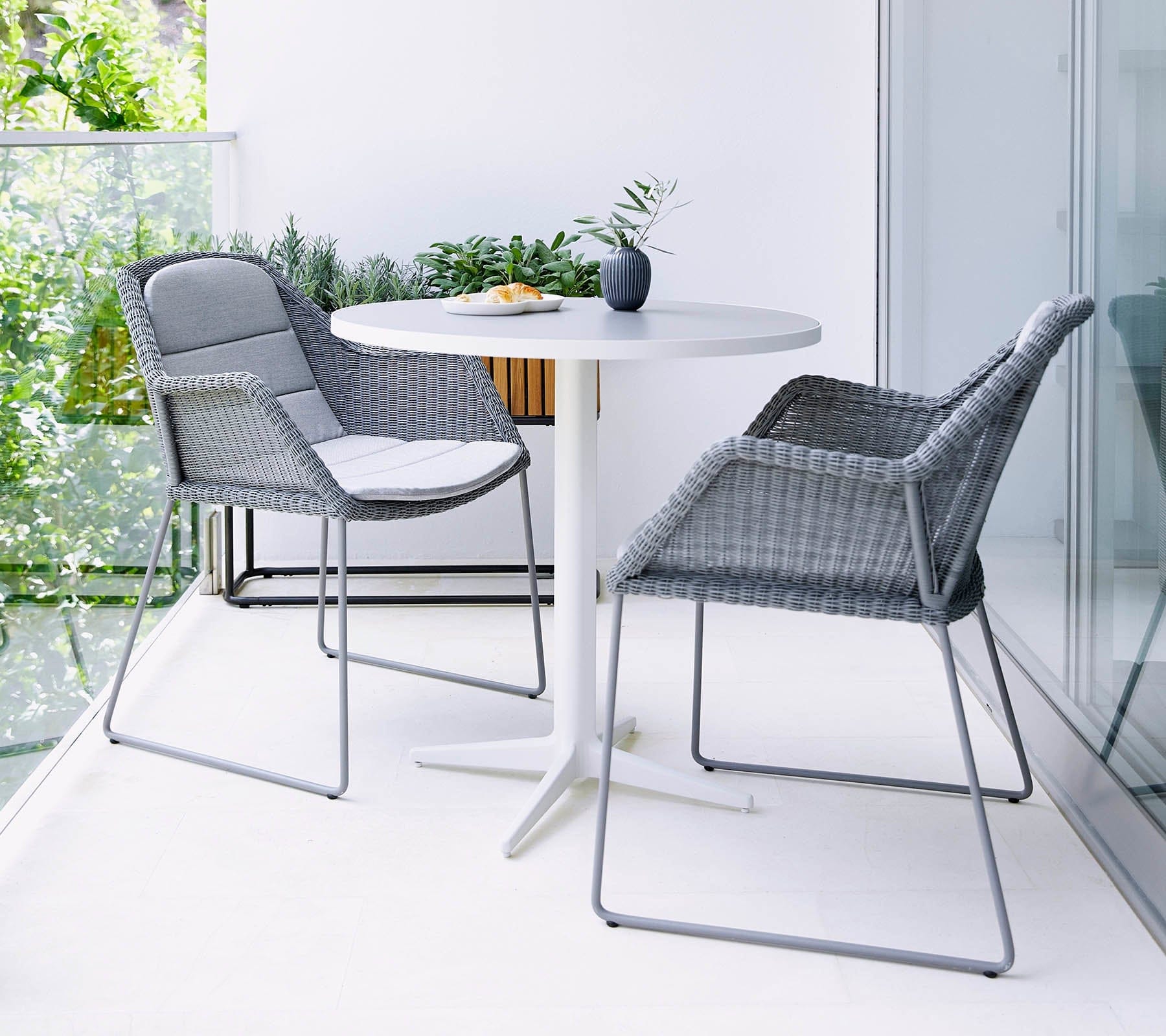 Boxhill's Breeze Dining Weave Chair Light Grey lifestyle image with round table in the balcony