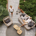 Boxhill's Basket 2-Seater Outdoor Sofa Natural lifestyle image top view with man sitting down and a woman standing beside