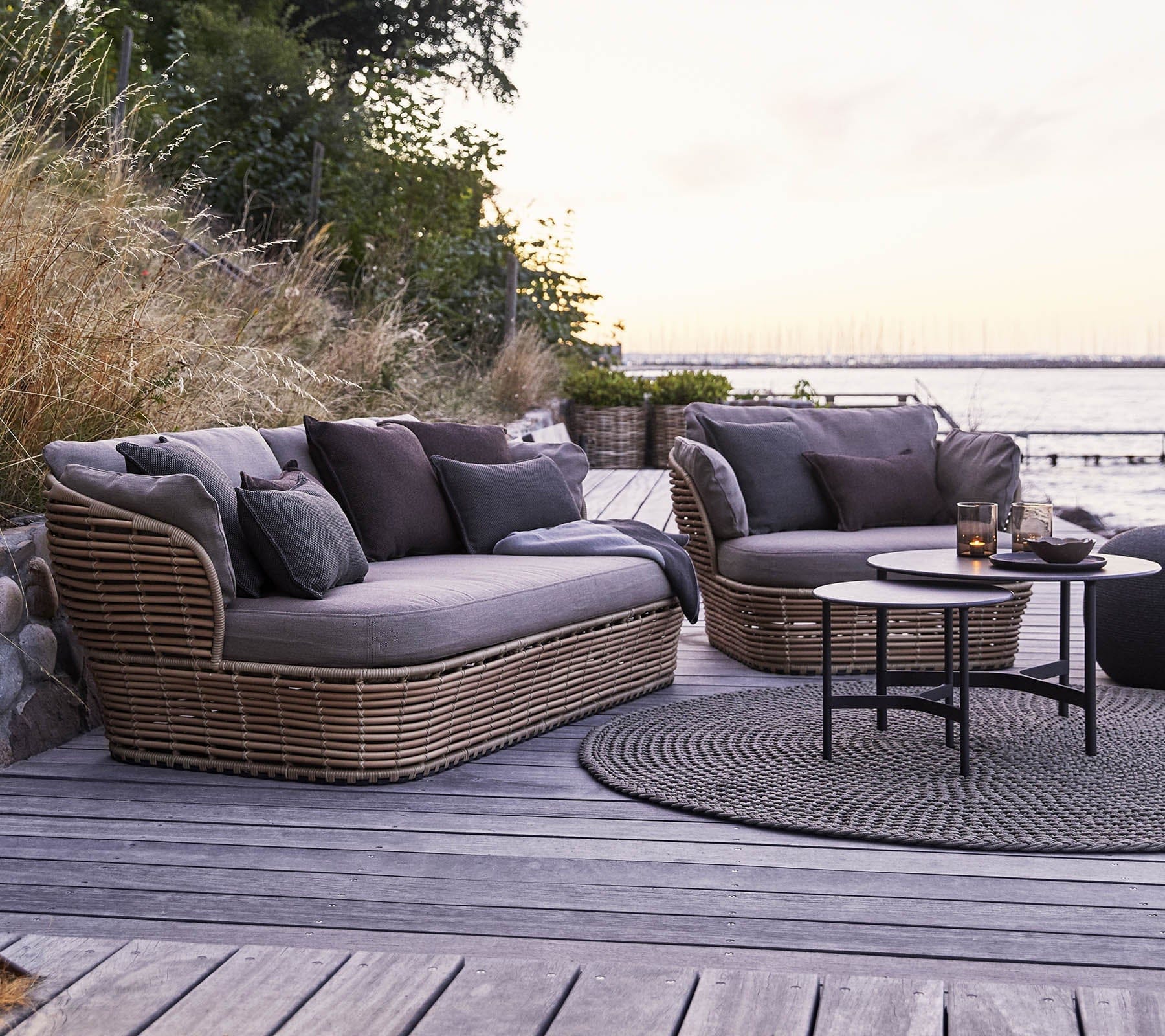 Boxhill's Basket 2-Seater Outdoor Sofa Natural lifestyle image on wooden platform