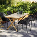 Boxhill's Breeze Stackable Dining Armchair (Set of 2) Black lifestyle image with wooden table in the garden