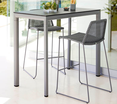 Boxhill's Breeze Bar Stackable Chair Grey lifestyle image with bar table