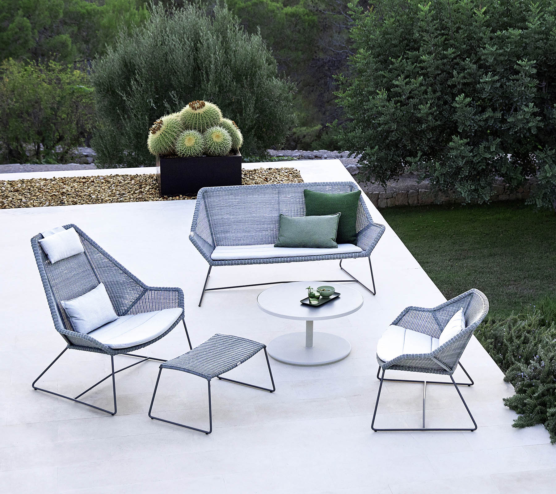 Boxhill's Breeze 2-Seater Outdoor Garden Sofa Light Grey lifestyle image in the garden