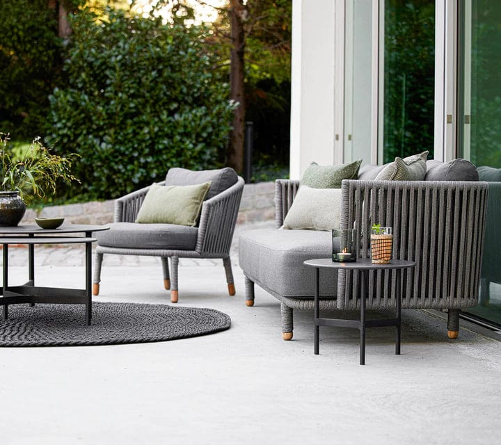 Boxhill's Moments 3-Seater Sofa lifestyle image with Moments Outdoor Lounge Chair and 2 round table at patio