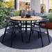 Boxhill's Circle Outdoor Rug Black lifestyle image at patio with dining chair and round table