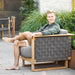 Boxhill's Angle Teak Frame Lounge Chair lifestyle image with a man sitting down