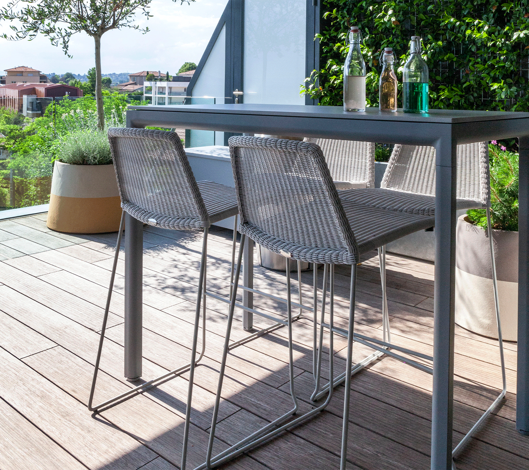 Boxhill's Breeze Bar Stackable Chair White lifestyle image with bar table on wooden platform balcony