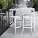 Boxhill's Cut Outdoor Aluminum Bar Table White lifestyle image with Cut High Outdoor Bar Chair at patio
