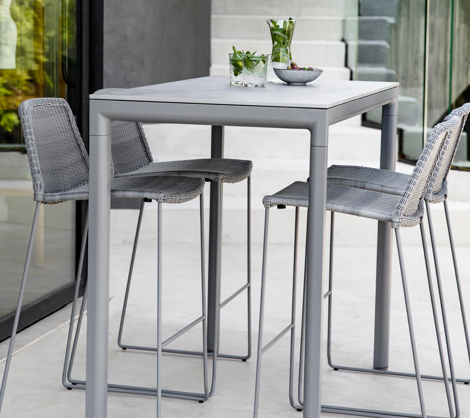 Boxhill's Breeze Bar Stackable Chair Grey lifestyle image with bar table