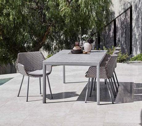 Boxhill's Vibe light grey / dusty rose outdoor armchair with light grey rectangular outdoor table placed in patio