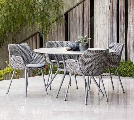 Boxhill's Vibe light grey outdoor armchair with light grey round outdoor dining table placed in patio