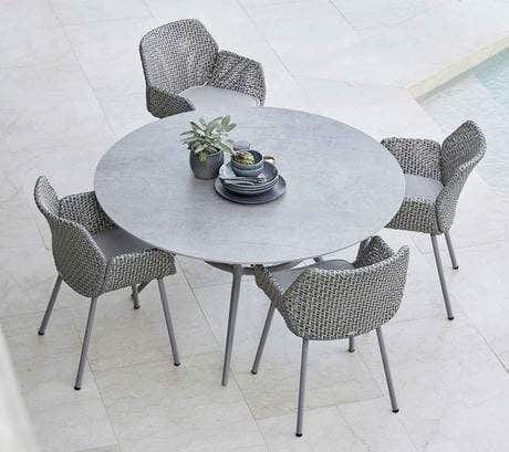 Boxhill's Vibe light grey outdoor armchair with light grey round outdoor dining table placed on poolside