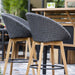 Boxhill's Peacock dark grey outdoor bar chair with teak legs with outdoor kitchen shelves placed in patio