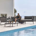 Boxhill's Conic Outdoor Coffee Table Grey lifestyle image with Conic Sectional Sofa and Conic Box Outdoor Storage Table with a woman sitting down