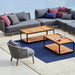 Boxhill's LEVEL Rectangle Coffee Table Lava Grey with Teak Table Top lifestyle image with sectional sofa beside the pool