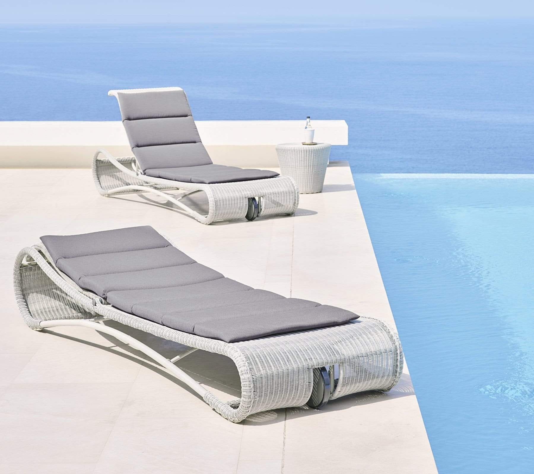 Boxhill's Escape Pool Side Sunbed White Grey Weave with Grey Cushion lifestyle image beside the pool