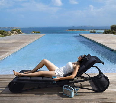 Boxhill's Escape Pool Side Sunbed lifestyle image with a woman lying down beside the pool