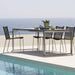 Boxhill's Straw dark grey outdoor armchair stainless steel frame  with grey outdoor dining table placed on poolside