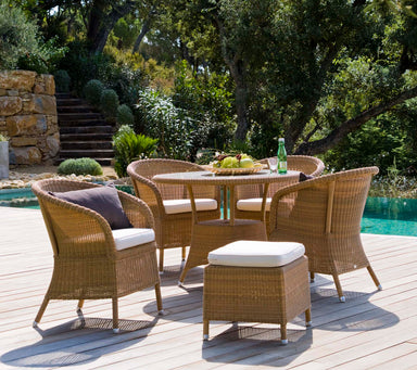 Boxhill's Derby Outdoor Dining Armchair lifestyle image with round table on wooden platform beside the pool