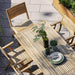 Boxhill's Flip Folding Outdoor Teak Dining Armchair lifestyle image with Flip Folding Outdoor Teak Dining Table at patio, top view