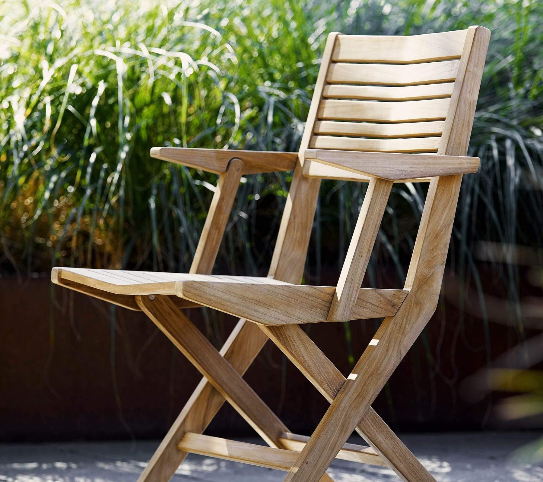 Folding ArmcBoxhill's Flip Folding Outdoor Teak Dining Armchair lifestyle image solo