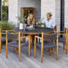 Boxhill's Aspect Teak Round Dining Table Fossil Black lifestyle image with man and woman sitting down