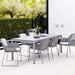 Boxhill's Drop Outdoor Dining Table Light Grey lifestyle image with Breeze Dining Weave Chair at patio