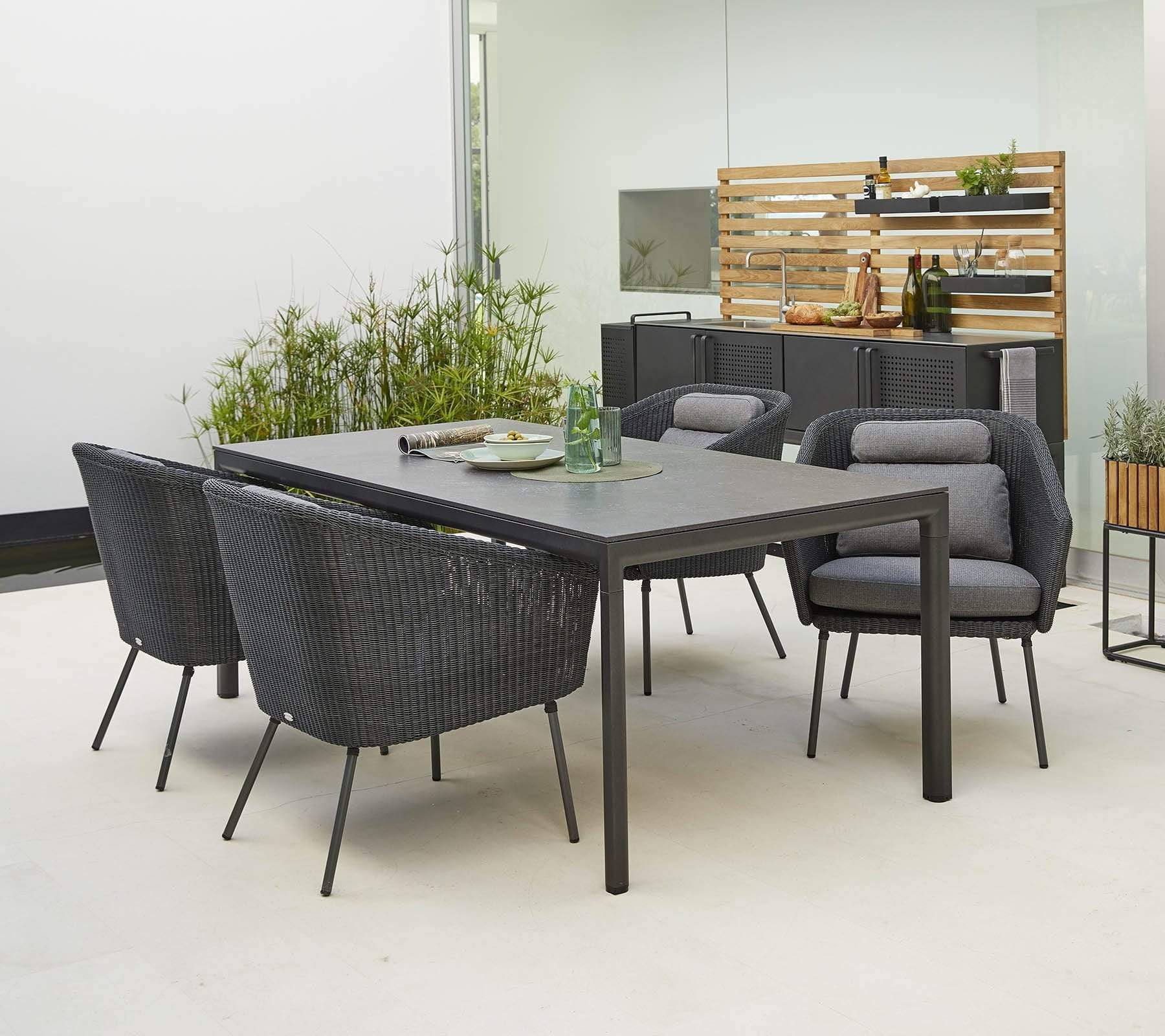 Boxhill's Drop Outdoor Dining Table Lava Grey lifestyle image with dining chair and Drop Outdoor Kitchen Module