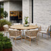 Boxhill's Endless Outdoor Round Dining Table lifestyle image with 6 dining chairs at patio
