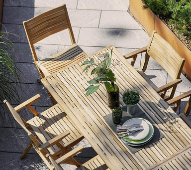 Boxhill's Flip Folding Outdoor Teak Dining Table Large lifestyle with Flip Folding Outdoor Teak Dining Armchair at patio, top view