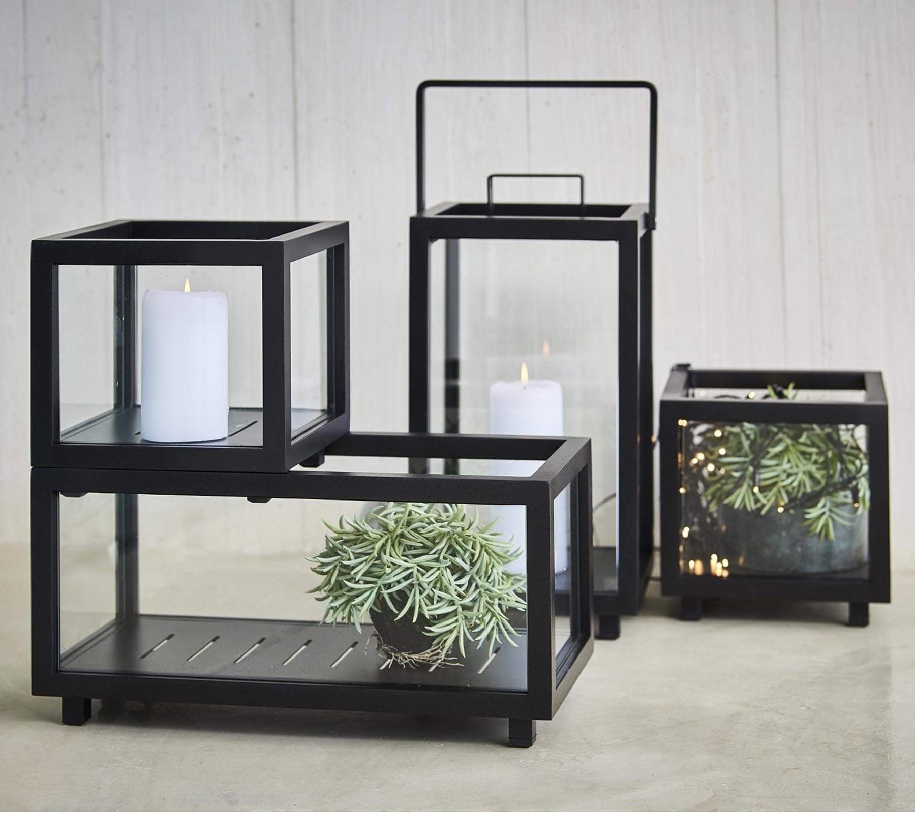 Boxhill's lava grey outdoor rectanglular light box together with other sizes of light box with candles and plants inside