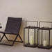 Boxhill's Lighthouse Outdoor Large Aluminum Lantern for Candles | Set of 2 lifestyle image beside the chair