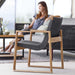 Boxhill's Endless Outdoor Lounge Chair lifestyle image with a woman sitting on a 3-seater sofa